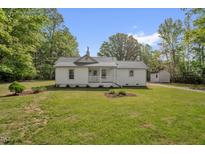 Charming single-story home with a well-manicured lawn and a cute front porch at 701 701 Oakwood St, Mebane, NC 27302