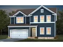 Two-story home featuring a dark blue exterior, attached garage, and well-maintained landscaping at 721 Denburn Pl, Raleigh, NC 27603