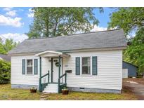 Charming single-story home featuring a welcoming front porch and well-maintained landscaping at 820 Southern St, Selma, NC 27576