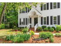 Charming two-story home with black shutters and a well-manicured front yard with mature landscaping at 8504 Boot Ct, Raleigh, NC 27615