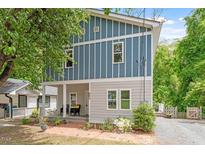 Charming two-story home with a blue and gray exterior and a cozy front porch at 905 Carroll St, Durham, NC 27701