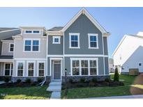 Charming new construction two-story home with gray and white exterior and manicured lawn at Lot 8 Cooper St, Sanford, NC 27330