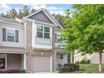 Charming townhouse featuring a brick facade, attached garage, and well-maintained landscaping at 11 Grifton Pl, Durham, NC 27704