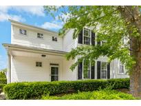 Inviting home showcasing manicured landscaping, a covered porch, and a classic white facade at 1121 Silky Dogwood Trl, Apex, NC 27502