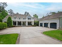 Stately two-story home features a balcony, large yard, and three car garage at 118 Duncansby Ct, Cary, NC 27511