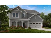 Charming two-story home featuring gray siding, a covered front porch, and an attached two-car garage at 132 Seagraves Creek Ln, Holly Springs, NC 27540