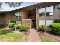 A charming two-story townhome with brown siding, brick accents, and a well-maintained landscaped yard at 1504 Oak Tree Dr, Chapel Hill, NC 27517
