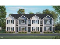 New two-story townhome showcases a charming facade with a landscaped yard and classic architectural details at 176 Holmes Corner Dr, Smithfield, NC 27577