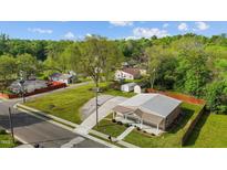 Aerial view of a charming home featuring a metal roof and lush green lawn at 212 Orange St, Oxford, NC 27565