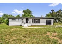 Charming renovated brick home featuring a well-manicured lawn and an attached garage at 2710 E Greensboro Chapel Hill Rd, Snow Camp, NC 27349
