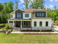 Beautiful two-story home with stone accents, manicured lawn, and modern design elements at 30 Futrell Ridge Ct, Chapel Hill, NC 27517