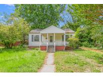 Modest single-story home featuring a small front porch and overgrown yard at 331 Highland Ave, Burlington, NC 27217