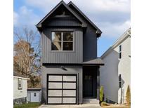Modern two-story home with a single-car garage, gray siding, and black trim at 425 Longfellow St, Fuquay Varina, NC 27526