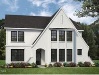 Charming two-story home with a brick facade, black trim windows, and manicured landscaping at 45 Addison Pond Ct # 11, Zebulon, NC 27597