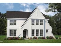 Charming two-story home with a white brick facade, black roof and lush green lawn at 45 Addison Pond Ct # 11, Zebulon, NC 27597
