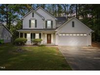 Charming two-story home with white siding, green shutters, and a well-manicured front lawn at 4500 Hollirose Pl, Raleigh, NC 27616