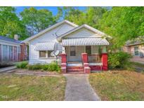 Charming single-story home with a covered front porch and awning-covered windows at 605 Dunbar St, Durham, NC 27701