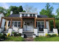 Charming renovated bungalow features a pergola-covered front porch and inviting curb appeal at 614 Henry St, Rocky Mount, NC 27803