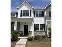 Charming two-story home features stone accents, black shutters, and a welcoming front porch at 743 Hadstock Path Path, Zebulon, NC 27597