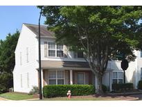 Charming two-story townhome with white siding, neutral shutters, well-maintained landscaping, and mature trees at 8511 Bright Loop, Raleigh, NC 27613