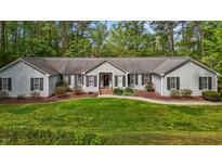 Charming single-story home with manicured front lawn and mature trees at 113 Denard St, Oxford, NC 27565