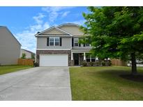 Charming two-story home with stone accents, a two-car garage, and well-maintained landscaping at 1145 Raven Perch Dr, Wendell, NC 27591