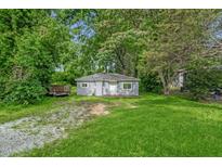 Charming exterior view of cozy home with lush greenery and light-blue painted siding at 1219 Junction Rd, Durham, NC 27704