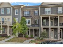 A charming townhouse with brick and siding, complemented by a well-manicured lawn at 1844 Austin Ridge Pkwy, Wake Forest, NC 27587