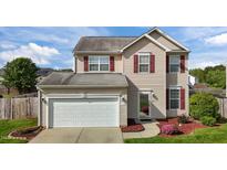 Charming two-story home with red shutters, well-maintained lawn, and attached two-car garage at 2503 Macdougall Dr, Burlington, NC 27217