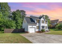 Two-story home features a driveway and attached one car garage at 2708 Tryon Pines Dr, Raleigh, NC 27603
