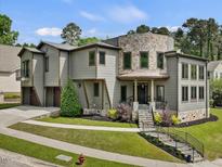 Striking home with unique architectural features and professional landscaping provides great curb appeal at 3315 Denada Path, Durham, NC 27707