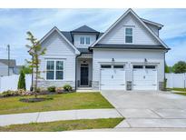 Charming two-story home with manicured lawn, two-car garage, and neutral-colored exterior at 49 Kathy Mae Ct, Angier, NC 27501