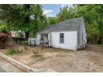 Charming single-story home featuring a fenced yard and mature trees at 511 E Maynard Ave, Durham, NC 27704