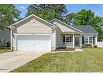 Charming single-story home featuring a front-facing garage and a welcoming porch with a decorative wreath at 8300 Neuse Hunter Dr, Raleigh, NC 27616