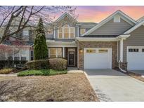 Charming brick and vinyl two-story home with well-maintained landscaping and attached two-car garage at 9207 Wooden Rd, Raleigh, NC 27617