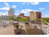 Relax on this rooftop deck with comfortable seating and a beautiful view of the city skyline at 101 Morris St # D, Durham, NC 27701