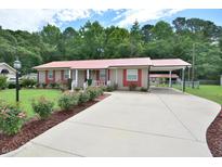 Charming single-story home with a manicured front yard and a long driveway at 113 Gulf Drive Dr, Dunn, NC 28334