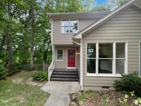 Charming two-story home with a inviting red front door and well maintained landscaping at 122 Mallard Ct, Chapel Hill, NC 27517
