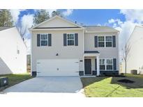 Charming two-story home featuring a two-car garage, classic shutters, and a well-manicured lawn at 139 Palm Drive Dr, Sanford, NC 27332