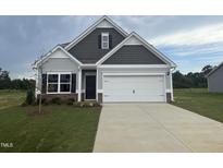 Charming two-story home with a manicured lawn and a two car garage at 202 E Victory View Ter, Smithfield, NC 27577