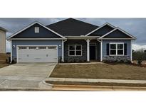 Charming single-Gathering home with a two-car garage, stone accents, and professionally landscaped yard at 244 Kipling Crk Dr, Fuquay Varina, NC 27526