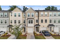 Attractive townhomes in neutral colors featuring attached garages and well maintained landscaping at 2617 Chert Ln, Raleigh, NC 27610