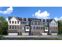 Charming townhome exteriors with a stone facade, multiple windows, and attached garages for convenient parking at 2885 Foster Woods Dr, Apex, NC 27502