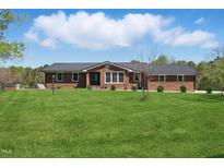 Charming brick home with well-maintained front yard and a metal roof at 3540 Sellars Rd, Mebane, NC 27302