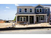 Two-story new construction home featuring mixed-material facade and covered front porch at 3714 Rosebush Dr, Zebulon, NC 27597