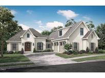 Inviting traditional home features a three-car garage, a manicured lawn, and neutral brick at 4002 Dublin Ct, Burlington, NC 27215