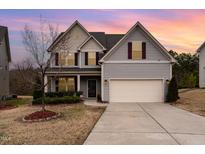 Charming two-story home with landscaped yard and attached two-car garage at 410 Pintail Ct, Durham, NC 27704