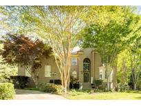 Charming home featuring a well-manicured lawn and mature trees providing ample shade and curb appeal at 5129 Bartons Enclave Ln, Raleigh, NC 27613