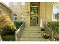 Inviting front entrance with detailed brickwork, wooden door and decorative wreath at 5129 Bartons Enclave Ln, Raleigh, NC 27613