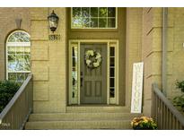 Charming home entrance with a wreath on the front door and a 'welcome' sign at 5129 Bartons Enclave Ln, Raleigh, NC 27613